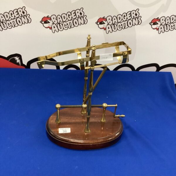 Vintage brass port pourer with mechanical lever action.