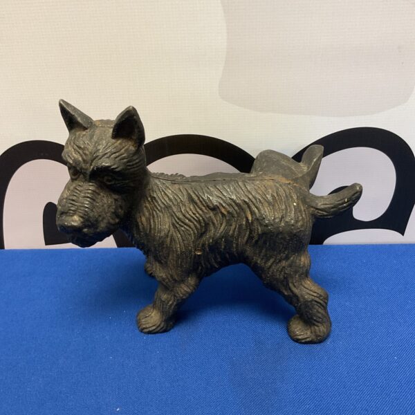 Vintage cast iron Scottie dog doorstop with rustic patina.