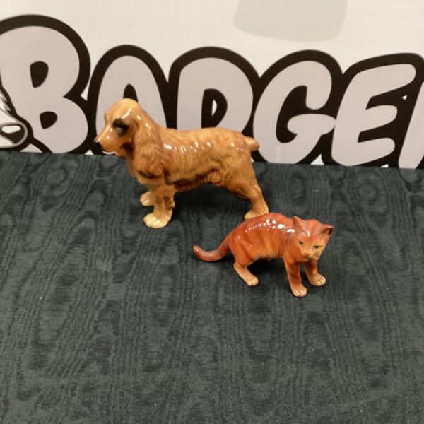 Vintage Coppercraft dog and cat figurines, a charming animal pair.