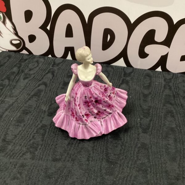 Delicate Coalport Spring Song figurine with floral details.