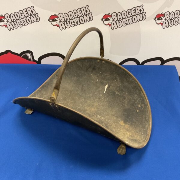 Antique steel and copper log basket for firewood storage.