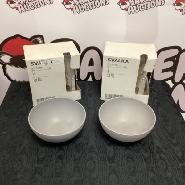 A set of twelve Svalka wine glasses and two bowls on display.