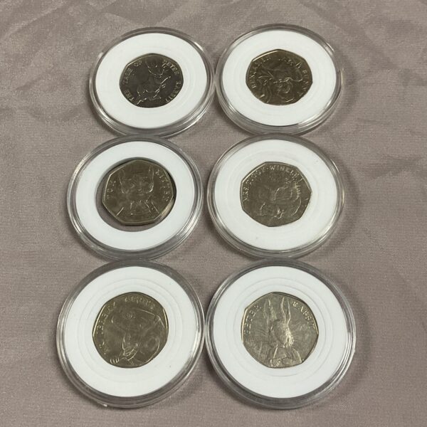 Set of six Beatrix Potter 50p coins in capsules.
