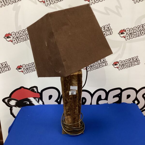 Rustic wooden table lamp with a unique, natural base.
