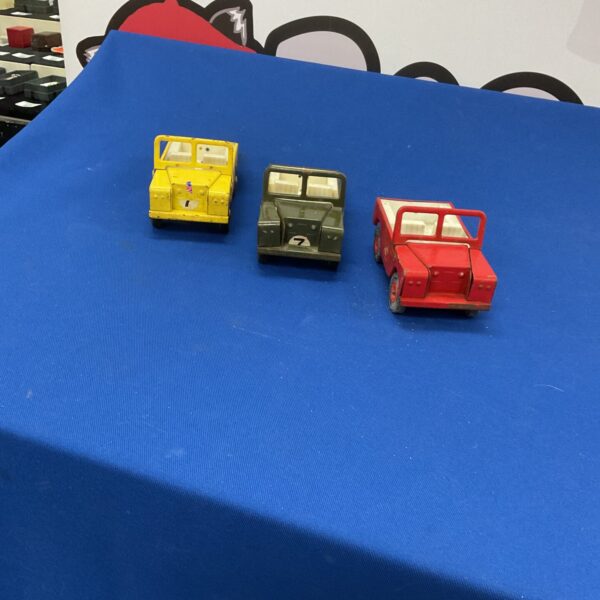 Lot of three vintage Triang Land Rovers, collectible tinplate toys.