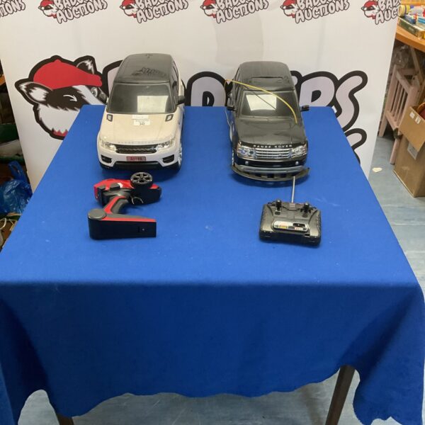 Two Range Rover toy cars with remote controllers for auction.