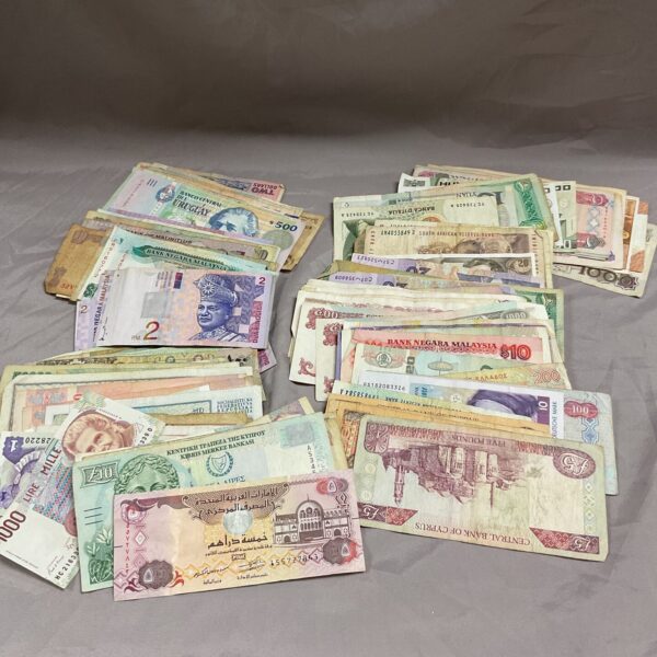 Diverse collection of foreign banknotes and world currency notes.