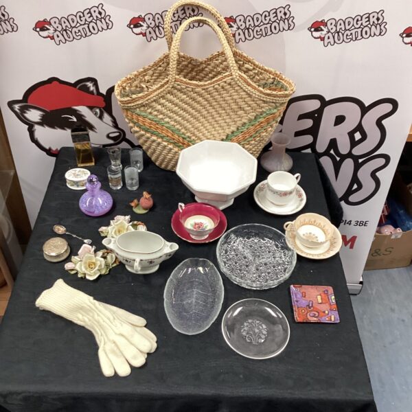Vintage wicker shopping bag filled with mixed collectibles and curios.