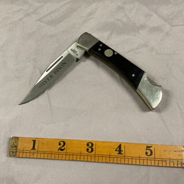 Vintage silver bison horn pocket knife with stainless steel blade.