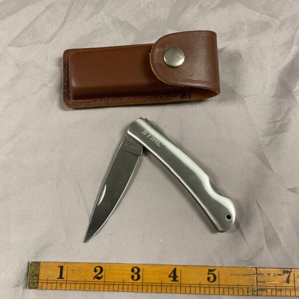Stihl pocket knife with leather pouch, stainless steel blade, vintage tool.