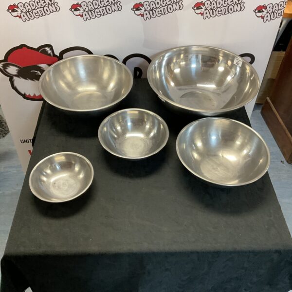 Set of three stainless steel serving dishes for catering.