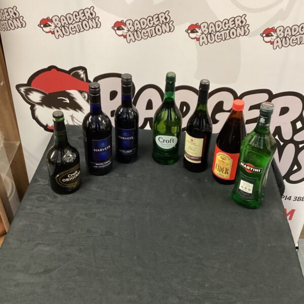 Vintage alcohol bottle collection including Harvey's and Martini.