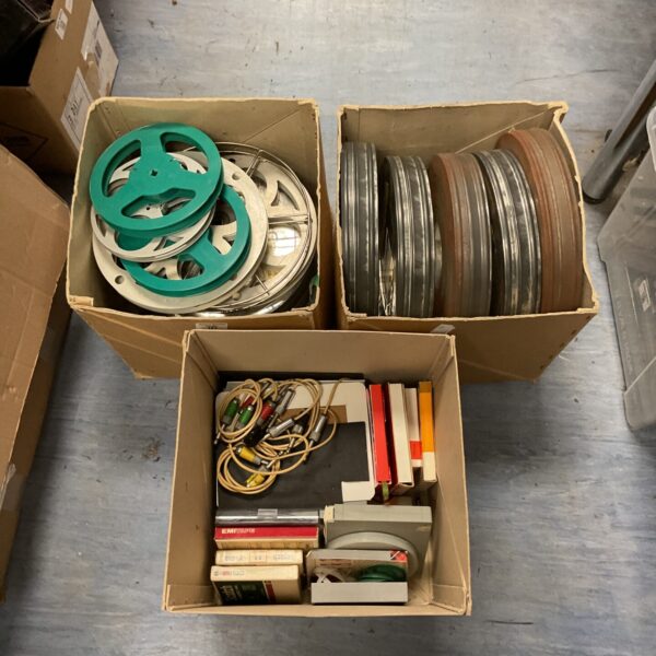 Mixed lot of vintage film reels and cans for collectors.