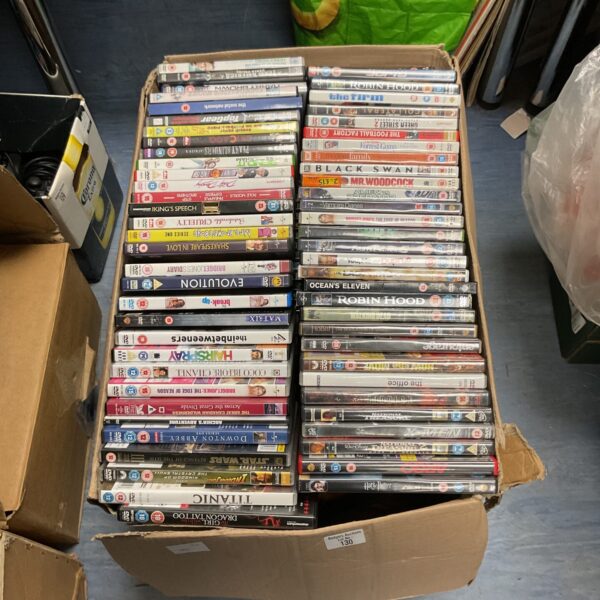 Large assortment of DVDs in a cardboard box, ideal for movie collectors.