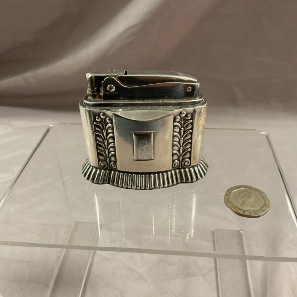 Vintage silver Ronson Diana table lighter with floral details.