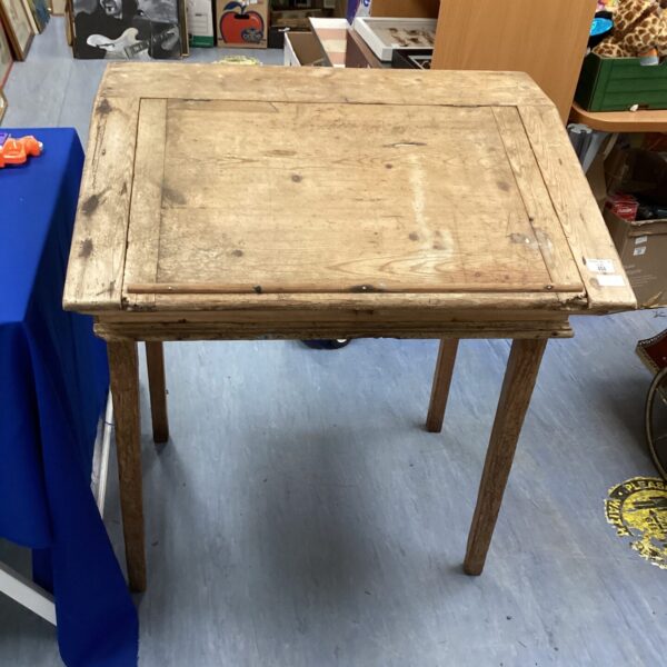 Front view of antique pine writing table with rustic charm.