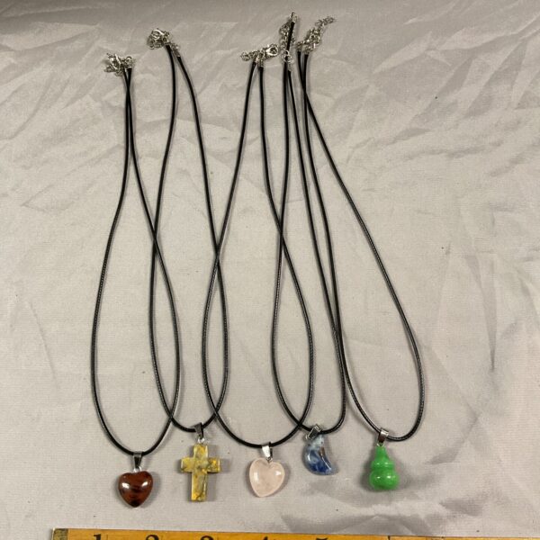 Lot of five stone pendant necklaces with varied pendants.
