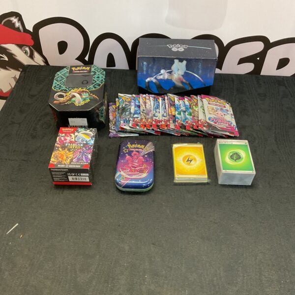 Pokemon card collection with tins and booster packs for trading card game.