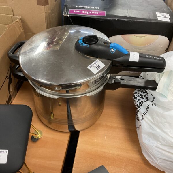 Vintage Steinbach pressure cooker in stainless steel, side view.