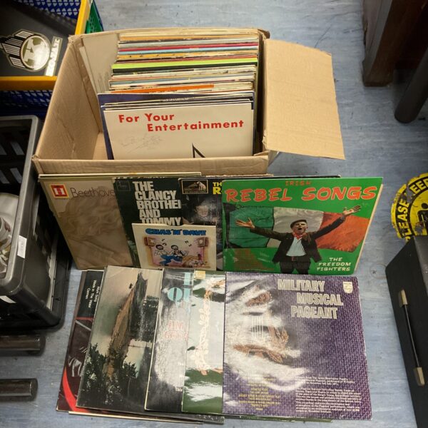 Assorted vinyl records in a box, vintage music collection.