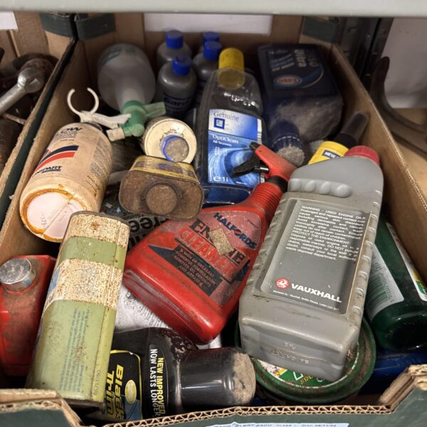 Tray of assorted shed clearance chemicals and automotive fluids.