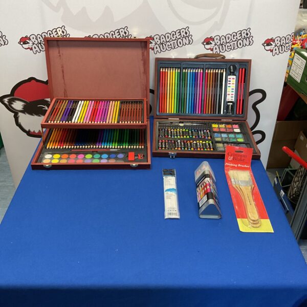 Artist storage boxes filled with colourful art supplies and brushes.