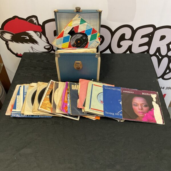 Vintage blue suitcase filled with 7” vinyl records, including Whitney Houston.