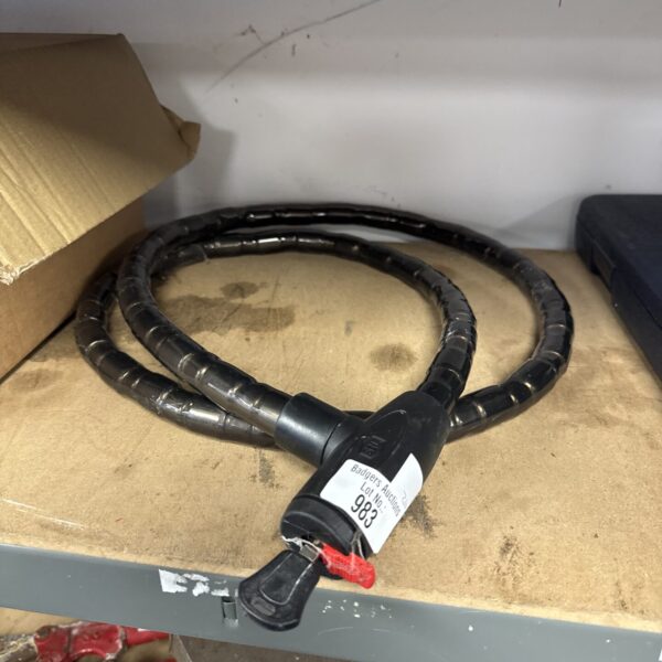 Close-up of an SL motorcycle security chain with a key lock.