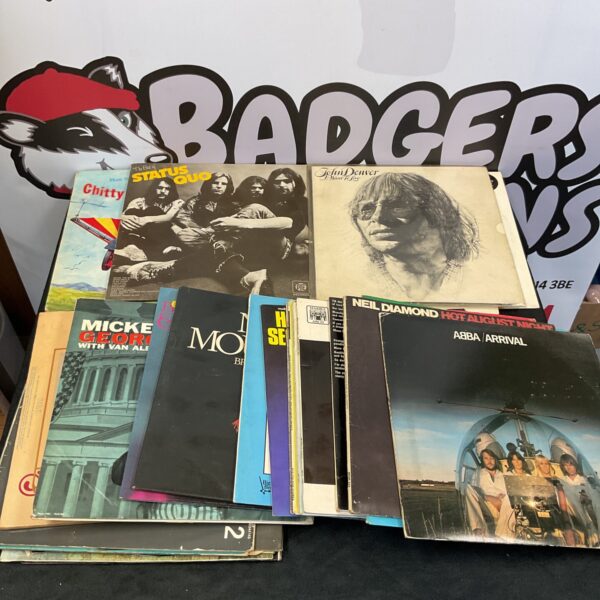 Vintage vinyl record collection featuring Status Quo and John Denver.