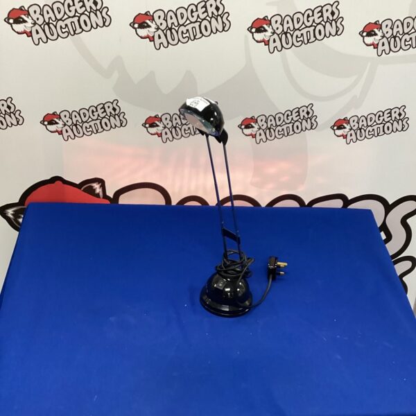 Black Ikea telescopic desk lamp for adjustable task lighting.