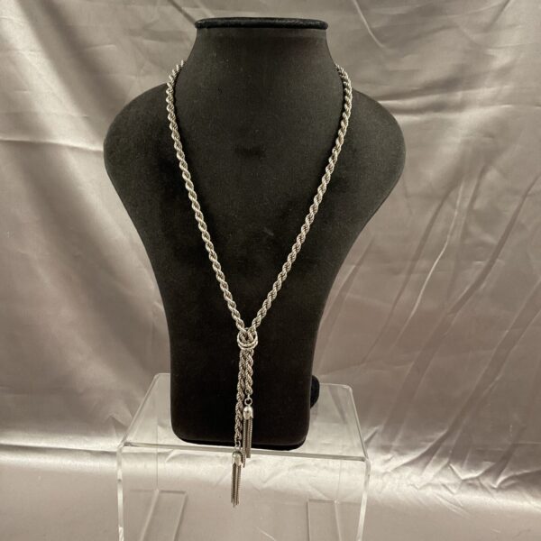 Silver rope chain necklace with tassel details, elegant jewellery.