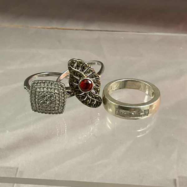 Close-up of a silver ring with a cluster of sparkling stones.