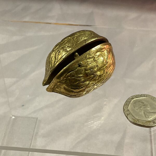 Antique ormolu walnut pill box, a gilded collectible trinket box.