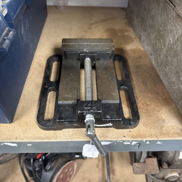 Vintage metalworkers clamp for securing metal during workshop tasks.