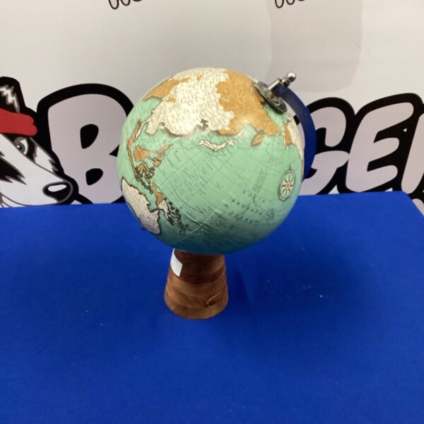 Detailed vintage desktop globe with world map on wooden base.