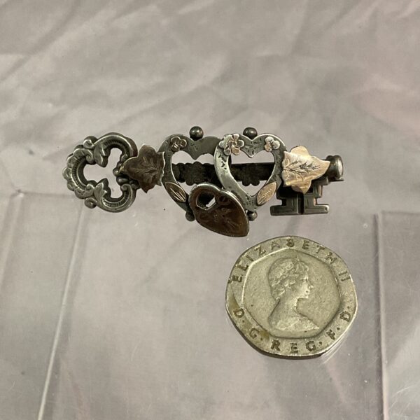 Vintage sweetheart brooch with silver key and rose gold heart.