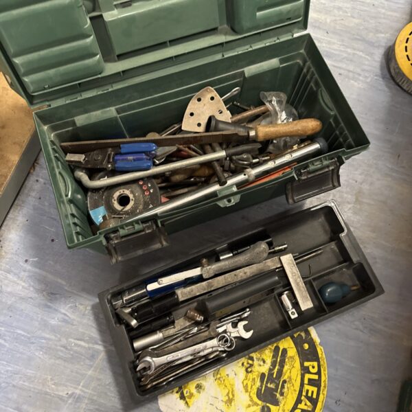 Vintage plastic toolbox filled with various hand tools.
