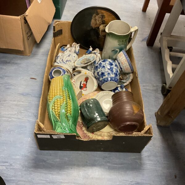 Mixed lot of vintage china and pottery on display.