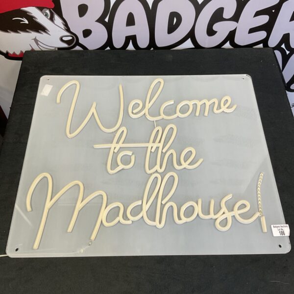 Bright neon ‘Welcome to the madhouse’ sign for retro decor.