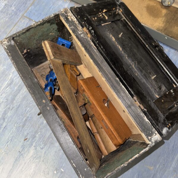 Vintage woodworker's tool box filled with antique woodworking tools.