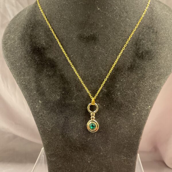 Silver gilt pendant necklace with aqua stone detail.
