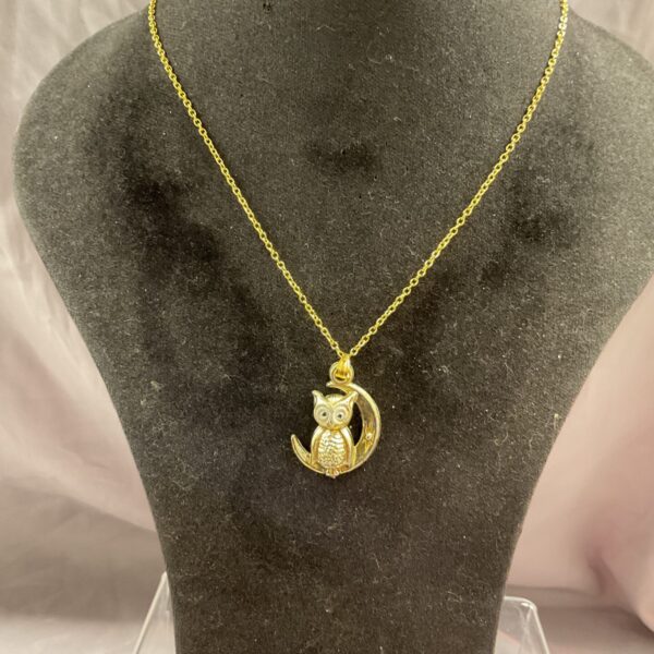 Silver gilt owl pendant necklace with moon design.