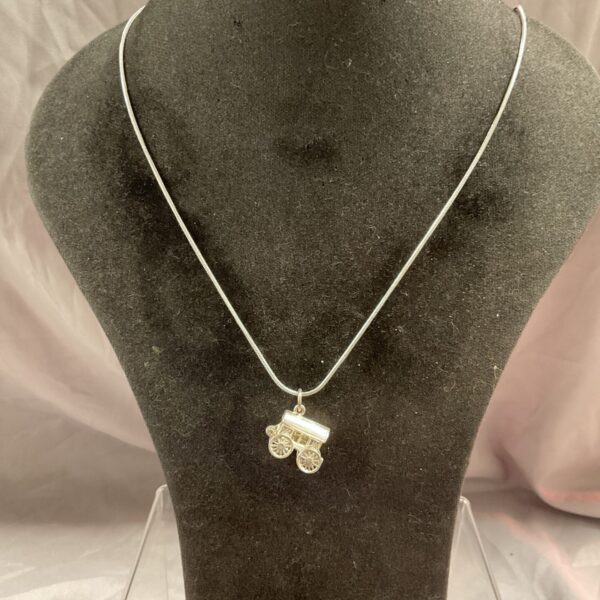 Detailed silver Romany caravan pendant on a snakelink chain.