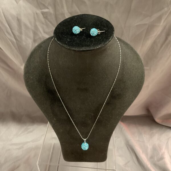 Silver blue ball necklace and earring set on display.