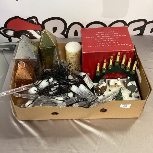 Box of vintage Christmas light decorations and festive tins.