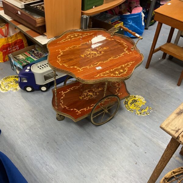 Vintage 1970s drinks trolley with inlaid wood detailing.