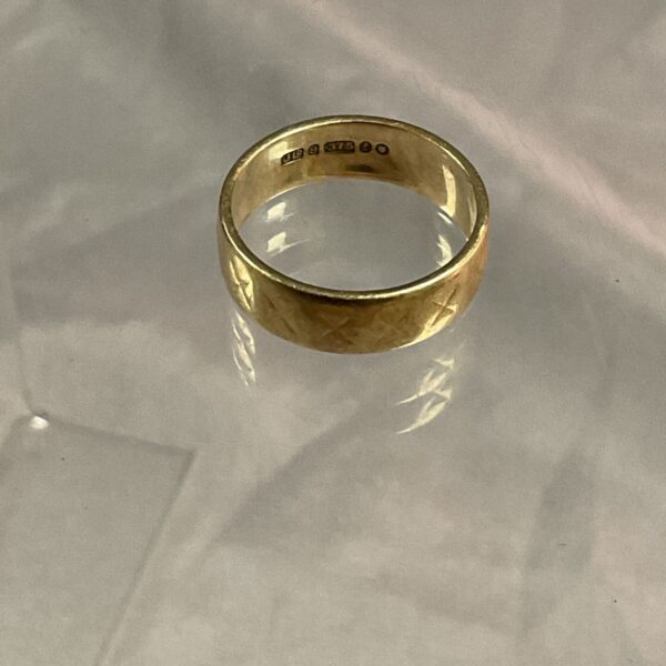 Close-up of a 9ct gold band ring, size L.