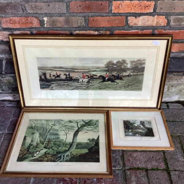 Set of three vintage hunt engravings in ornate frames.