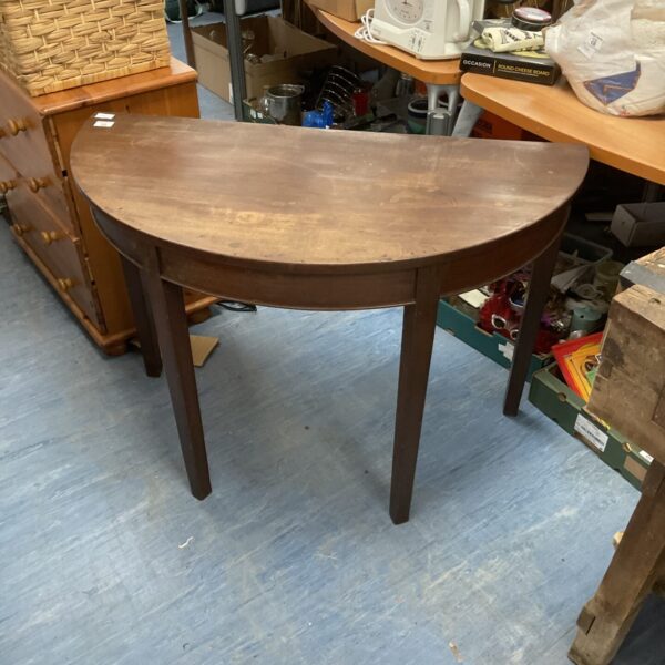 Antique mahogany demi-lune table with square legs.