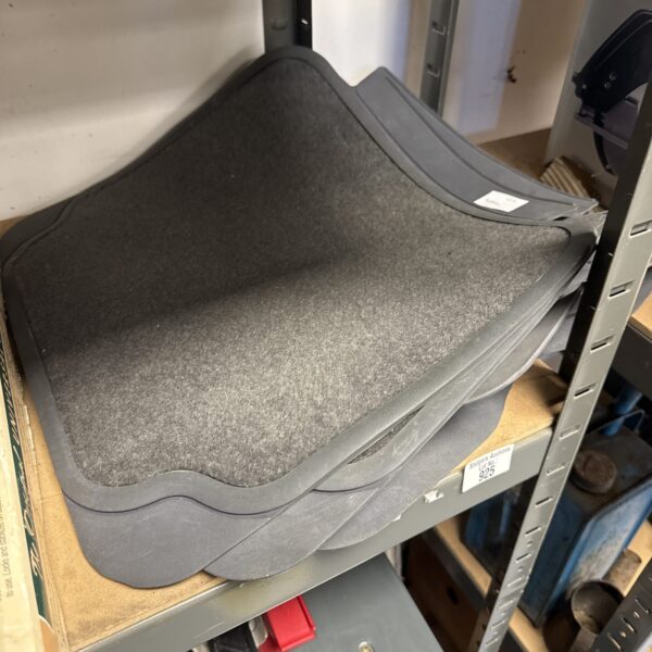 Used car mats for vehicle floor protection, showing signs of wear.